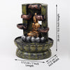 A resin table-top fountain featuring a statue of Lord Buddha, with water flowing around or from the statue.