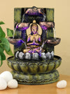 A resin table-top fountain featuring a statue of Lord Buddha, with water flowing around or from the statue.