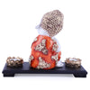 Captivating baby Buddha idol crafted from resin and marble, accompanied by a wooden tray and two tealight holders, symbolizing wisdom and tranquility