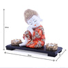 Captivating baby Buddha idol crafted from resin and marble, accompanied by a wooden tray and two tealight holders, symbolizing wisdom and tranquility