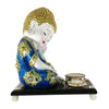 Blue Baby Buddha statue adorned with mirrors and fancy stones, accompanied by a wooden platform, fancy flower, and tealight holder