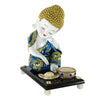 Blue Baby Buddha statue adorned with mirrors and fancy stones, accompanied by a wooden platform, fancy flower, and tealight holder