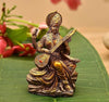 Handmade idol of Goddess Saraswati playing sitar, crafted from premium resin, showcasing intricate details, ideal for home decor or altars.