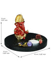 Handmade Ganesha idol in red and gold polyresin with a lotus-shaped tealight holder, showcasing intricate details. Ideal for altars and home decor."