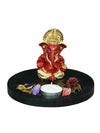 Handmade Ganesha idol in red and gold polyresin with a lotus-shaped tealight holder, showcasing intricate details. Ideal for altars and home decor."