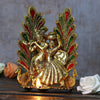 Peacock design Radha Krishna idol with diya, intricately crafted in metal, perfect for enhancing your puja room or as a thoughtful gift.