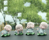 Set of four smiling little monk figurines made from resin, perfect for home decor or car dashboard embellishments, radiating tranquility and positivity